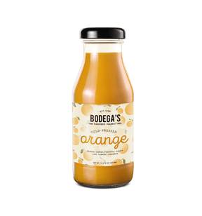 Glass bottle of orange juice with roll-fed branded label