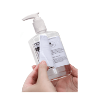 Hands holding sanitizer bottle with specialty label that folds out