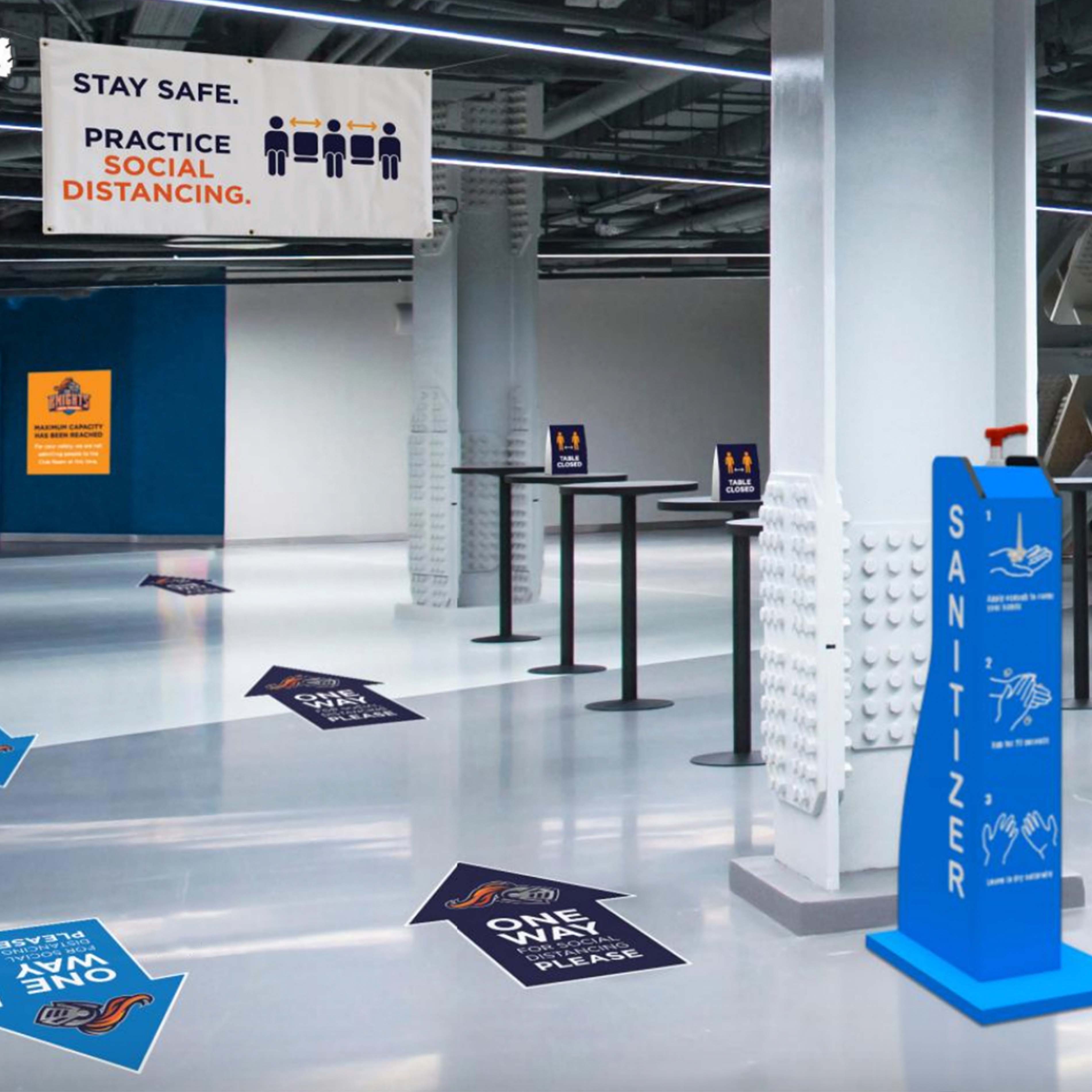 stadium entrance with floor decals, banner and sanitizer station