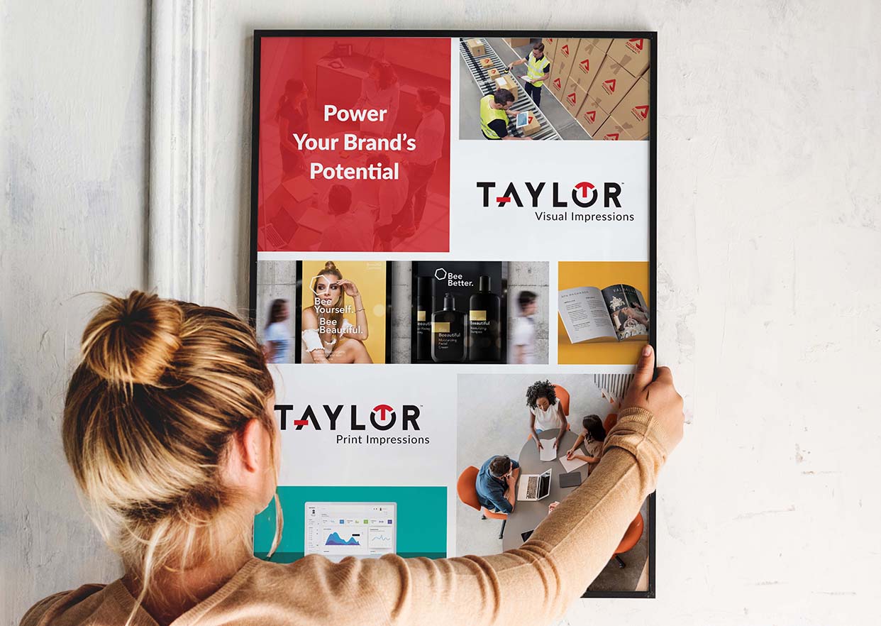 A woman hangs a Taylor-branded poster