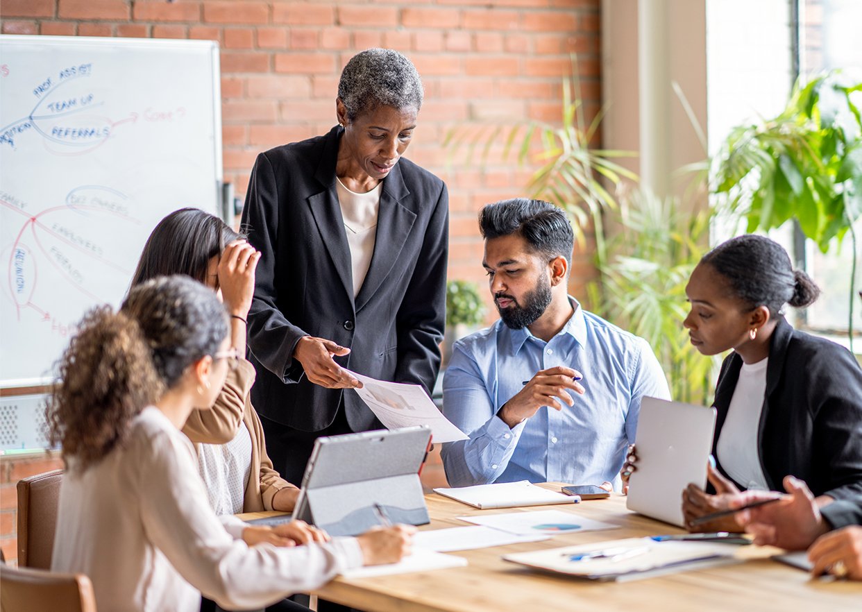 A healthcare team around a table discussing supplier diversity