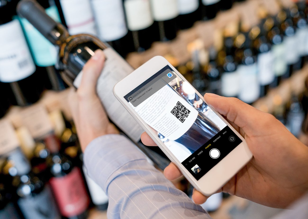 shopper using QR code on wine bottle