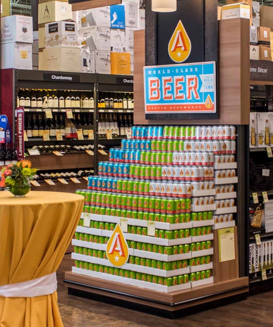 Wine and spirits beverage display with branded signage 