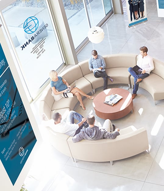 Banking customers enjoy quality customer experience while meeting in bank’s comfortable and naturally-lit lounge area