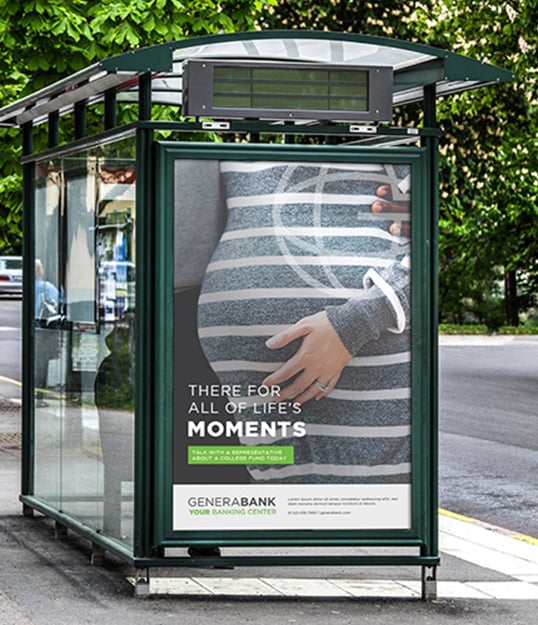 Bus stop shelter on a street corner featuring a retail bank promotional poster discussing life’s big moments.