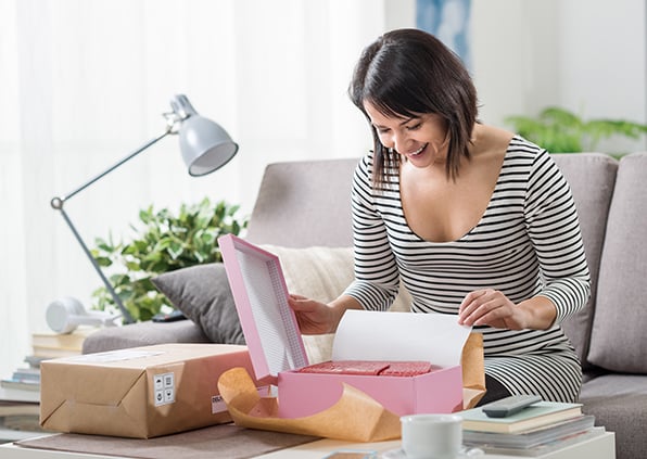 Woman opening fulfillment package