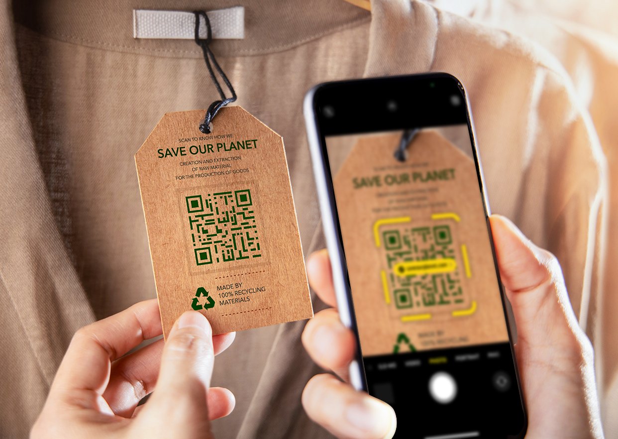 A shopper scanning a QR code on a product tag on a shirt with their smart phone.